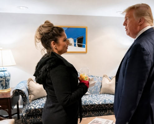 Katie Price speaking with a senior U.S. official during a strategic policy discussion