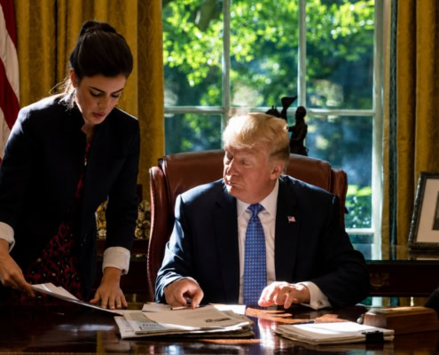Madeleine Westerhout reviewing documents with a senior U.S. official in the Oval Office