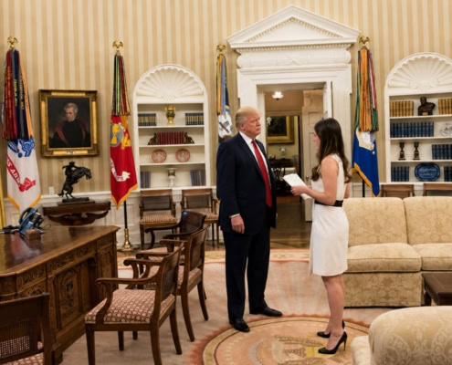 Madeleine Westerhout speaking with a senior U.S. official in the Oval Office