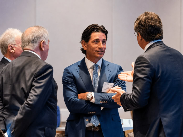 Business leaders discussing geopolitical consulting strategy at a professional conference
