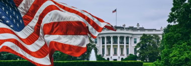 White House and U.S. flag representing geopolitical consulting on policy and government
