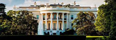 White House exterior with landscaped gardens, representing U.S. AI policy and regulatory guidance.