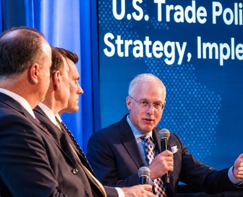 Experts discuss U.S. trade policy and implementation strategies during a business panel discussion.