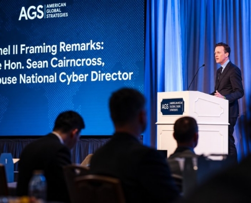 Speaker delivering opening remarks at the AGS Geopolitical Leadership Summit in front of an audience.